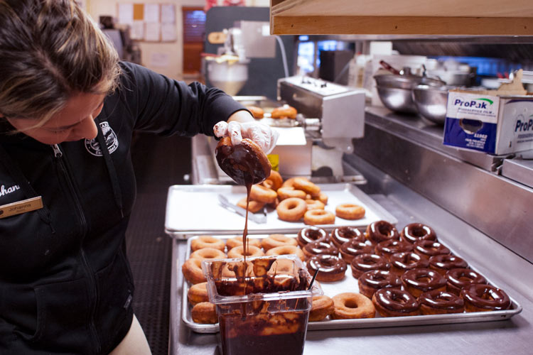 Dipping donuts in chocolate