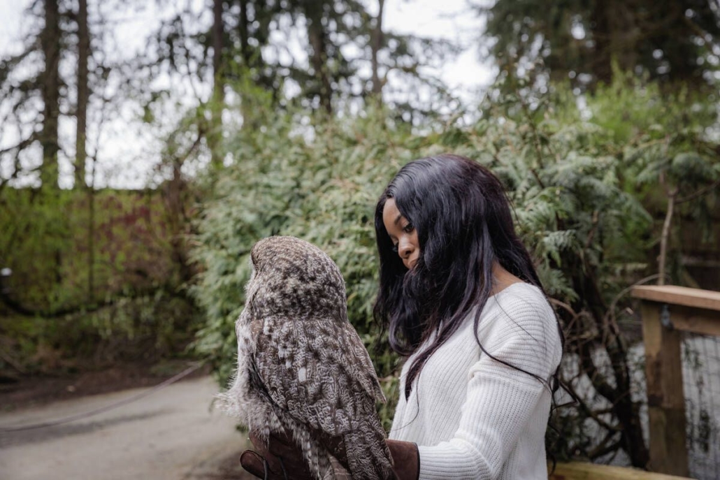 A woman holds an owl at The Raptors near Duncan photo by Tourism CowichanPeter O'Hara