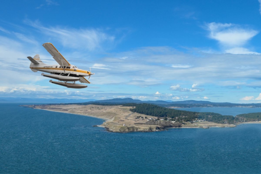 Kenmore Air de Havilland Otter flying past Cattle Point Lighthouse